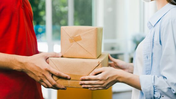 man delivering parcel to woman